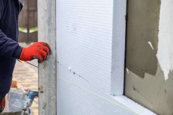 Fixation de panneaux isolants en polystyrène sur façade dans le cadre d'une ITE à Pau – Tuheil Établissement